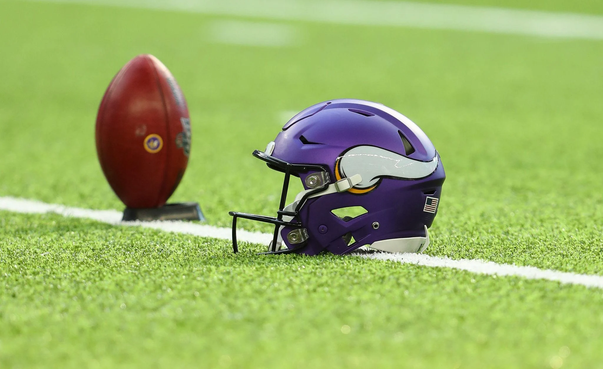 Minnesota Vikings helmet and football on turf symbolizing Rondale Moore Injury Update and current recovery status